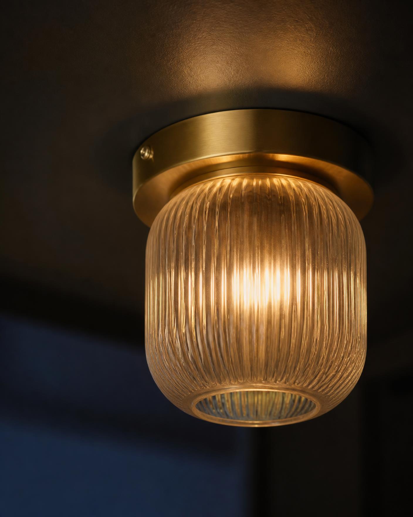 Close-up of an illuminated ceiling fixture mounted in a finished interior